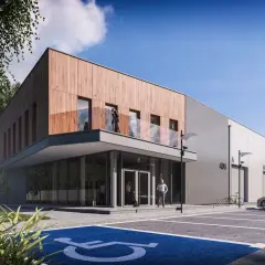 Nowoczesne projekty magazynów z drewnianą elewacją i betonem. Przed budynkiem parking z miejscem dla niepełnosprawnych i samochodem.