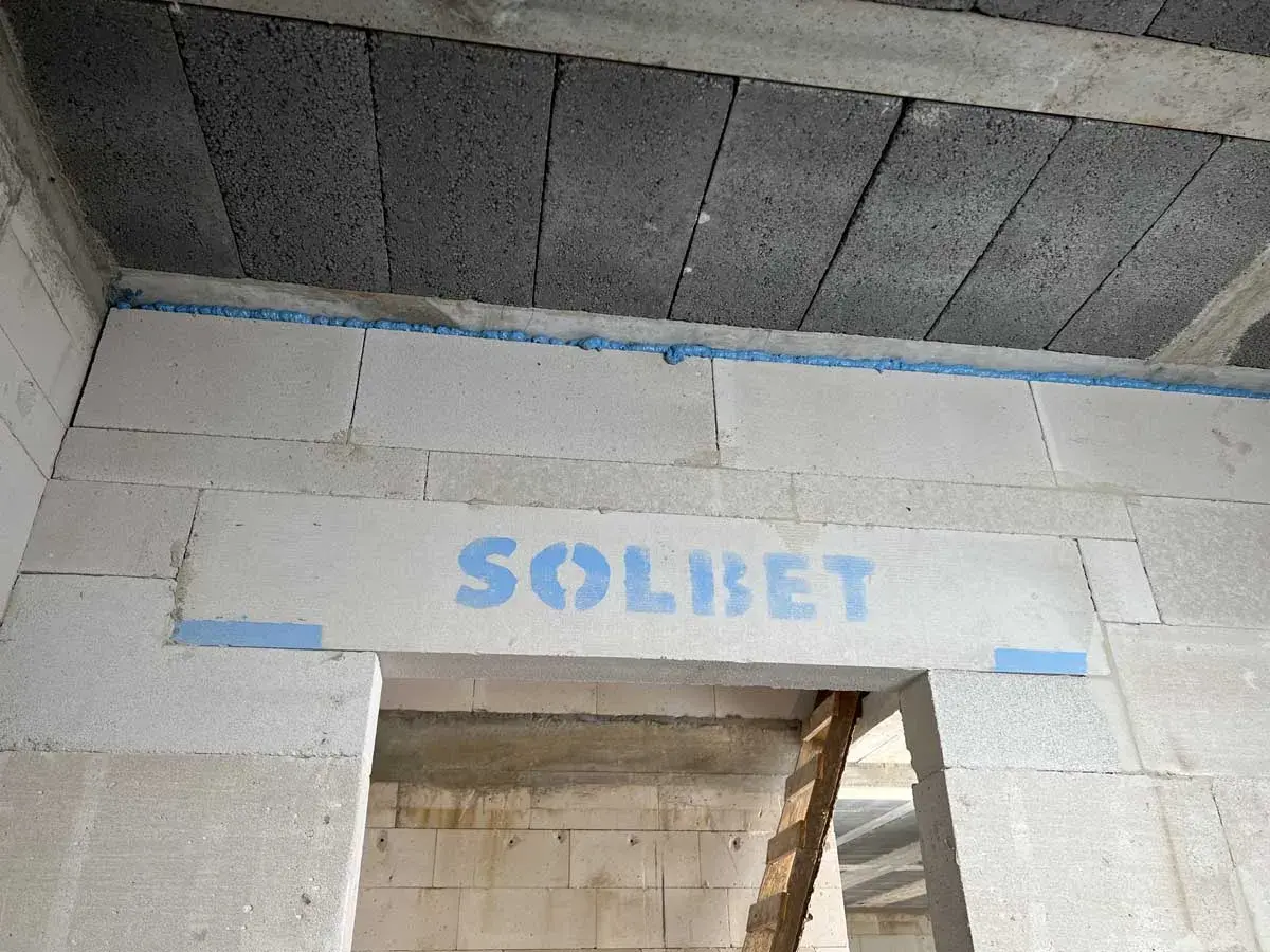 Dylatacja posadzki z pianki montażowej na styku ścian z bloczków SOLBET i stropu.
